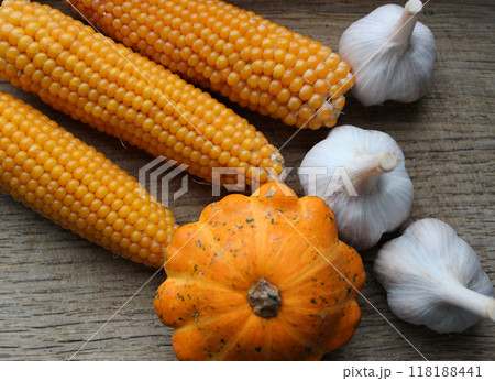 Corn Cobs, Summer Squash And Garlic On A Wood Board Stock Photo  118188441
