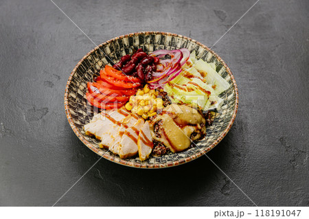 Healthy quinoa bowl with chicken, vegetables, beans, and dressing for a nutritious and balanced meal Healthy quinoa bowl with chicken, vegetables, beans, and dressing for a nutritious and balanced meal 118191047