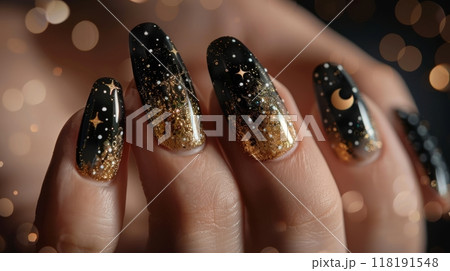 Hand with black and gold moon and star nails. Macro shot with glitter for nail art design 118191548