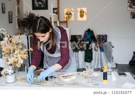 Woman crafting resin art in an artistic workspace for a small business. Creative entrepreneurship, DIY decor, handmade crafts, artisan studio, interior styling. Woman crafting resin art in an artistic workspace for a small business. Creative entrepreneurship, DIY decor, handmade crafts, artisan studio, interior styling. 118192077