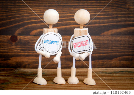 Urologist and Gynecologist. Two speech bubbles and miniature people on a wooden texture background 118192469