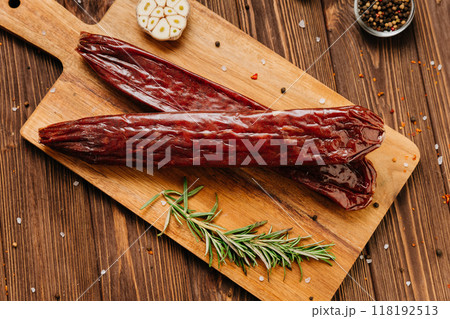 Traditional salami sticks with garlic and herbs, perfect for gourmet meals and charcuterie boards Traditional salami sticks with garlic and herbs, perfect for gourmet meals and charcuterie boards 118192513