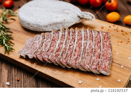 Traditional dry cured sausage slices on board with spices and herbs, perfect for food photography Traditional dry cured sausage slices on board with spices and herbs, perfect for food photography 118192537