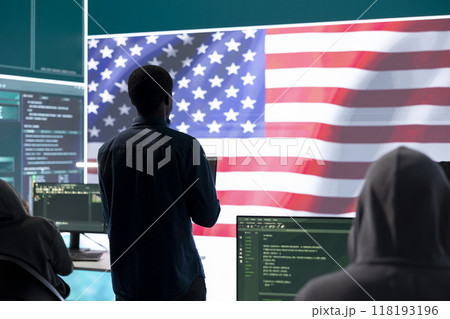 A technical team in a governmental cyber environment with the USA flag. Focus on cybersecurity strategy, threat management and secure operations for national security and digital defense. A technical team in a governmental cyber environment with the USA flag. Focus on cybersecurity strategy, threat management and secure operations for national security and digital defense. 118193196