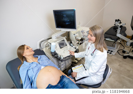 Young pregnant woman having appointment at female doctor Young pregnant woman having appointment at female doctor 118194668