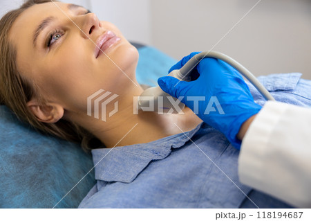 Doctor working with a patient in clinic on ultrasonography apparatus Doctor working with a patient in clinic on ultrasonography apparatus 118194687