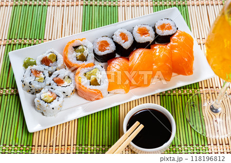 Set of different types of sushi served with sauce soy on board in cafe 118196812