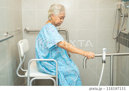 Asian elderly woman patient use toilet bathroom handle security in nursing hospital, healthy strong medical concept. 118197131