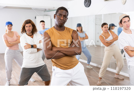 Happy multiracial men women of different ages performing dynamic energetic dancing movements in modern loft studio 118197320