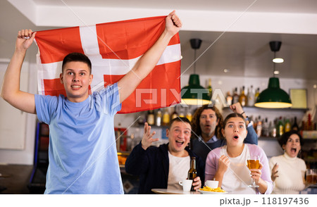Joyful fans of the Denmark team celebrating the victory in night bar 118197436