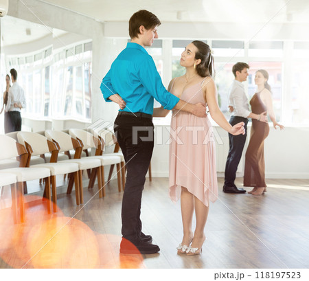 Happy girls paired with guys dance waltz in dance studio 118197523