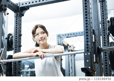 スポーツジムでトレーニングする若い女性 スポーツジムでトレーニングする若い女性 118198456
