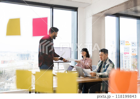 Meeting of creative professionals in modern office setting 118199843