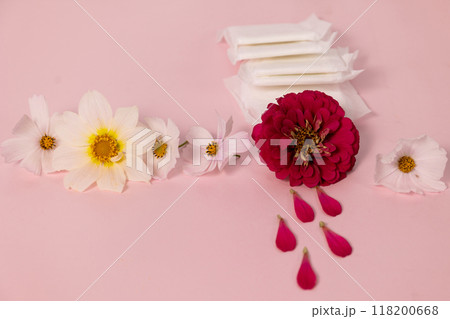 flowers and sanitary pads beautifully arranged on a pink background, aesthetics of menstruation 118200668