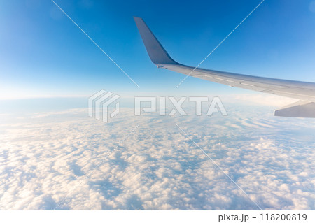 Beautiful salmon dawn and the wing of an airplane above the clouds. Beautiful salmon dawn and the wing of an airplane above the clouds. 118200819