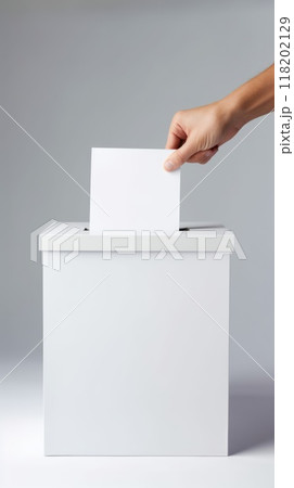 Civic duty - hand placing a ballot paper in ballot box for voting, emphasizing importance of election concept, showcasing anonymity of secret ballot, reflecting competitive nature of preelection race. 118202129
