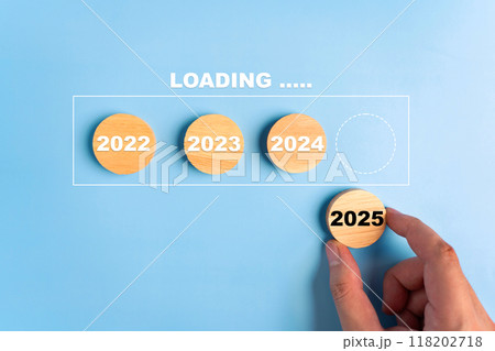 Man hand is using wooden blocks with the word 2025 to fill in the year section. 2025 New Year concept. Man hand is using wooden blocks with the word 2025 to fill in the year section. 2025 New Year concept. 118202718