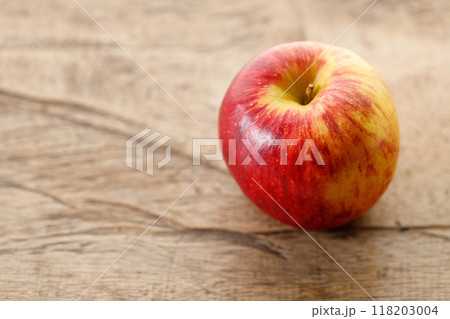 Ripe organic red apple on wooden table background. Ripe organic red apple on wooden table background. 118203004