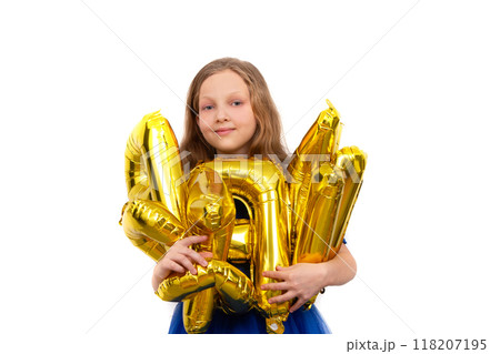 Little girl in a festive blue dress holds a golden set of happy birthday inflatable letters. Isolated on a white background. Little girl in a festive blue dress holds a golden set of happy birthday inflatable letters. Isolated on a white background. 118207195
