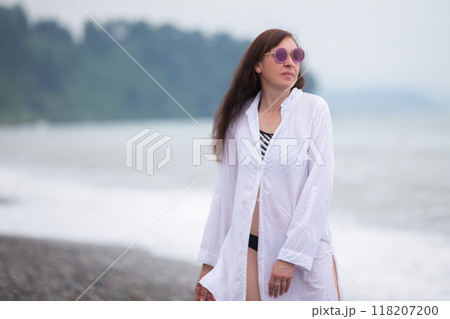 A beautiful middle-aged woman is relaxing at a resort, walking and enjoying her vacation. 118207200