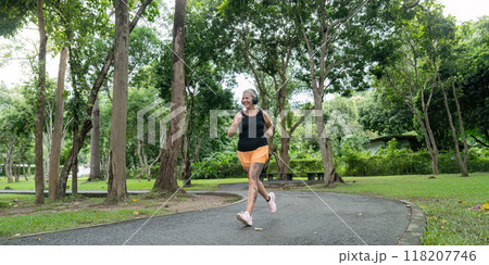 Senior Woman Jogging in a Lush Green Park on a Sunny Day for Healthy Lifestyle and Fitness Senior Woman Jogging in a Lush Green Park on a Sunny Day for Healthy Lifestyle and Fitness 118207746