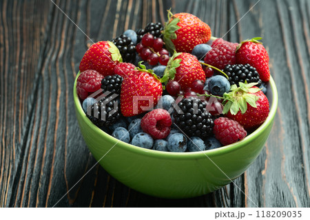 Mix of ripe colorful berries in bowl photography . Blueberry , strawberry , raspberry , blackberry and red currant . Top view Mix of ripe colorful berries in bowl photography . Blueberry , strawberry , raspberry , blackberry and red currant . Top view 118209035