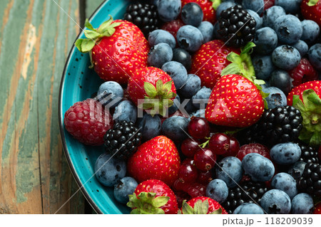 Mix of ripe colorful berries in bowl photography . Blueberry , strawberry , raspberry , blackberry and red currant . Top view Mix of ripe colorful berries in bowl photography . Blueberry , strawberry , raspberry , blackberry and red currant . Top view 118209039