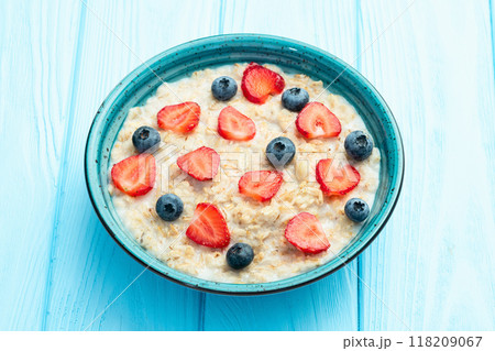 Homemade breakfast . Oatmeal with milk and berries . Top view 118209067