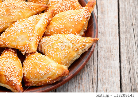 Homemade triangle puff pastry with meat on rustic background . Samosa Homemade triangle puff pastry with meat on rustic background . Samosa 118209143