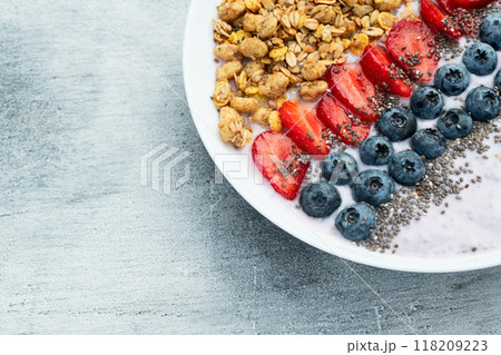 Healthy breakfast . Yogurt with berries ( strawberry , raspberry , blueberry , blackberry ) , granola and chia seeds . Top view Healthy breakfast . Yogurt with berries ( strawberry , raspberry , blueberry , blackberry ) , granola and chia seeds . Top view 118209223