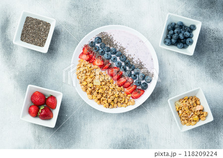 Healthy breakfast . Yogurt with berries ( strawberry , raspberry , blueberry , blackberry ) , granola and chia seeds . Top view Healthy breakfast . Yogurt with berries ( strawberry , raspberry , blueberry , blackberry ) , granola and chia seeds . Top view 118209224