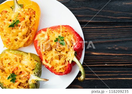 Baked stuffed pepper ( paprika ) with rice , carrot and meat . Top view on rustic background 118209235