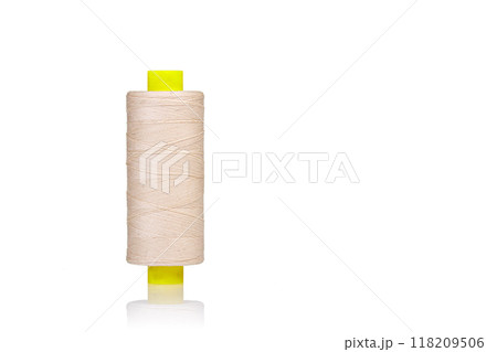 skein of beige color thread macro on a white background 118209506