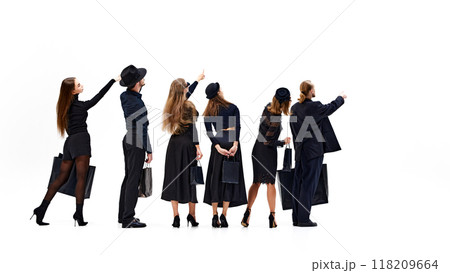 Group points forward in unison, as if directing their collective attention toward shared destination against white studio background. 118209664