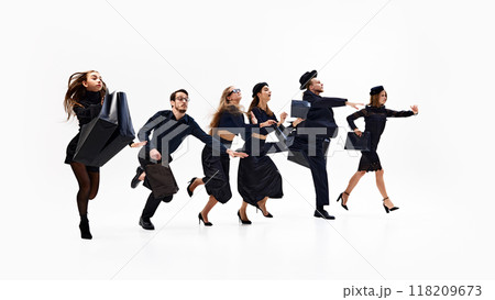 Group of chic shopper dressed total-black looks, sprinting enthusiastically, with bags in hand, against white studio background. 118209673