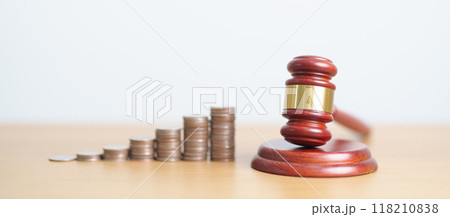 judge gavel with money coins stack on desk. Law cost, lawyer, judgment, justice auction and bidding concepts 118210838