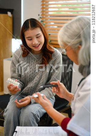 Senior female psychiatrist prescribing medication to a female patient during a consultation Senior female psychiatrist prescribing medication to a female patient during a consultation 118212687