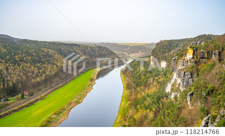 Overlooking the serpentine Elbe River, a visitor enjoys the vista from Bastei Bridge in Saxon Switzerland National Park. Kurort Rathen, Germany 118214766