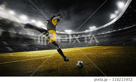 As game near to end, focused on victory soccer player dribbling and kicks ball on green field with full force to score goal under stadium's electric glow. As game near to end, focused on victory soccer player dribbling and kicks ball on green field with full force to score goal under stadium's electric glow. 118215952