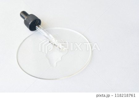 Minimalist skincare concept featuring serum dropper and transparent Minimalist skincare concept featuring serum dropper and transparent 118218761