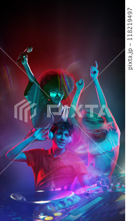 Poster. Feel pulse of neon nights as beats combine with colors, where DJ and singer light up night in surreal fusion of sound and energy. Poster. Feel pulse of neon nights as beats combine with colors, where DJ and singer light up night in surreal fusion of sound and energy. 118219497