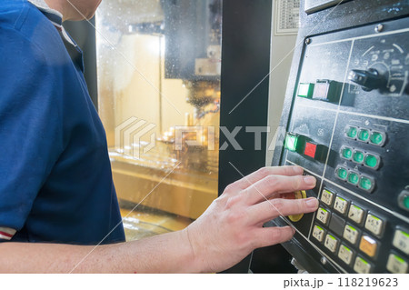 Close up scene the CNC machine operator working with CNC milling machine. 118219623