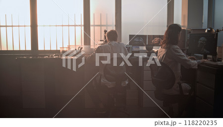 Mature microbiologist conducts fossil analysis using microscope in archaeological laboratory 118220235