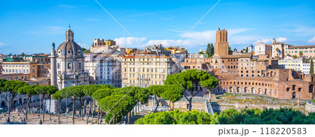 Visitors admire impressive architecture of Trajan Market in Rome, Italy, surrounded by lush greenery and historical buildings. The vibrant atmosphere highlights the rich heritage of the ancient city. Visitors admire impressive architecture of Trajan Market in Rome, Italy, surrounded by lush greenery and historical buildings. The vibrant atmosphere highlights the rich heritage of the ancient city. 118220583