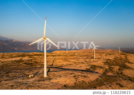 PAG ISLAND, CROATIA - JULY 14 2024: Wind turbines placed on Pag Island for alternative energy production. Modern technology to transform wind into sustainable source of power in Croatia PAG ISLAND, CROATIA - JULY 14 2024: Wind turbines placed on Pag Island for alternative energy production. Modern technology to transform wind into sustainable source of power in Croatia 118220615