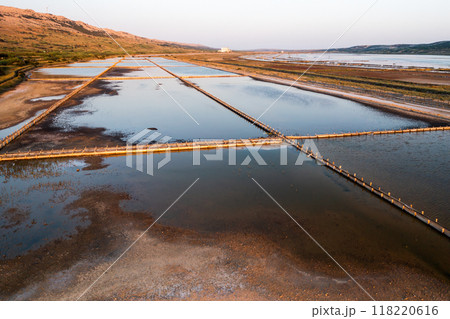 Shallow basins for sea salt production on Pag island in Croatia. Specialized equipment to produce natural product using traditional method Shallow basins for sea salt production on Pag island in Croatia. Specialized equipment to produce natural product using traditional method 118220616