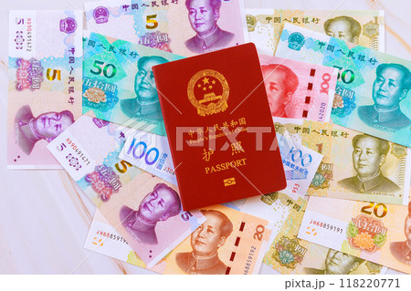Passport issued by People Republic of China is accompanied by cash yuan money banknote of various denominations Passport issued by People Republic of China is accompanied by cash yuan money banknote of various denominations 118220771