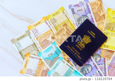 Passport Republic of India containing Indian rupees of various denominations 118220784