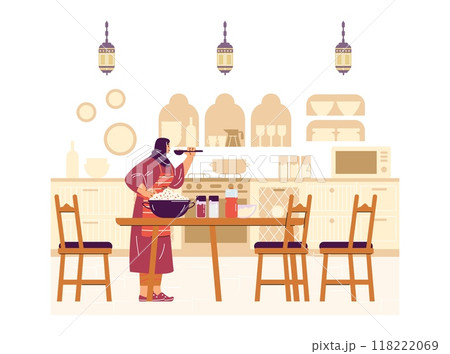 An oriental woman is preparing a festive pilaf in the kitchen. 118222069