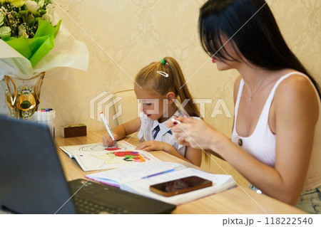 Mother and daughter engage in creative coloring activity at home Mother and daughter engage in creative coloring activity at home 118222540